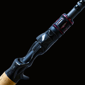 Close-up of a fishing rod handle with cork grip on a textured gray background