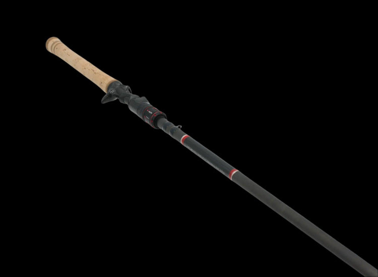 The Doozie Series 710 Flip/Punch Heavy Cover Casting Rod by Keeper Rods-Doozie features a cork handle, black shaft, and red accents. Its shown diagonally against a plain black background.