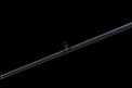 The Doozie Series 72 MH X-Ray Precision Power Heavy Cover Rod by Keeper Rods-Doozie is a black fishing rod with red accents and a cork handle, highlighted against a black background. Its sleek design features multiple eyelets, making it perfect for bass fishing enthusiasts.