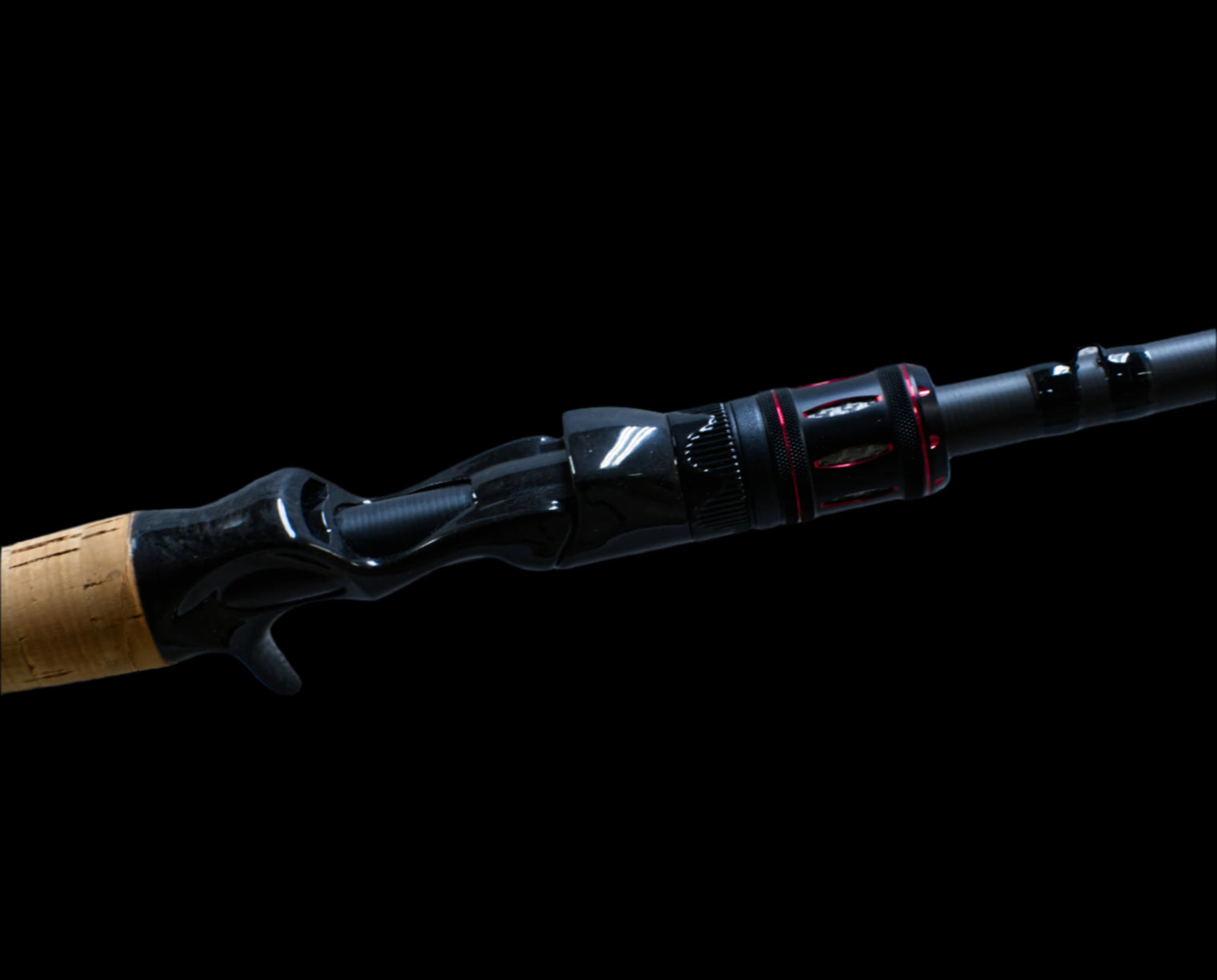 The Doozie Series 72 MH X-Ray Precision Power Heavy Cover Rod by Keeper Rods-Doozie is a black fishing rod with red accents and a cork handle, highlighted against a black background. Its sleek design features multiple eyelets, making it perfect for bass fishing enthusiasts.
