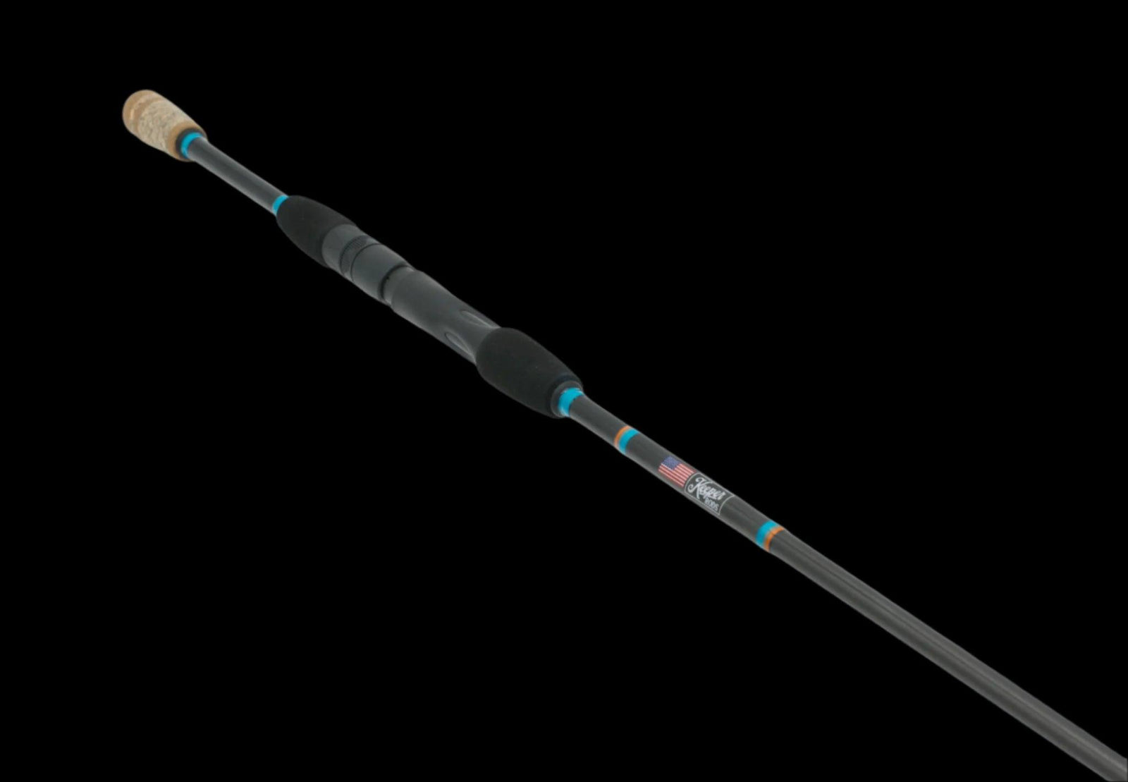 The Rouser 69 ML Fast Ultra-Sensitive Finesse Rod by Keeper Rods-FishStix features a sleek black carbon fiber blank with blue accents. Its cork handle ensures comfort, while the sturdy grip and an American flag logo near the base make it ideal for finesse fishing enthusiasts.